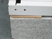 下地がコンクリートの場合は、木板などの端材をブロックと床板の間に挟んで水平になるよう調整します。